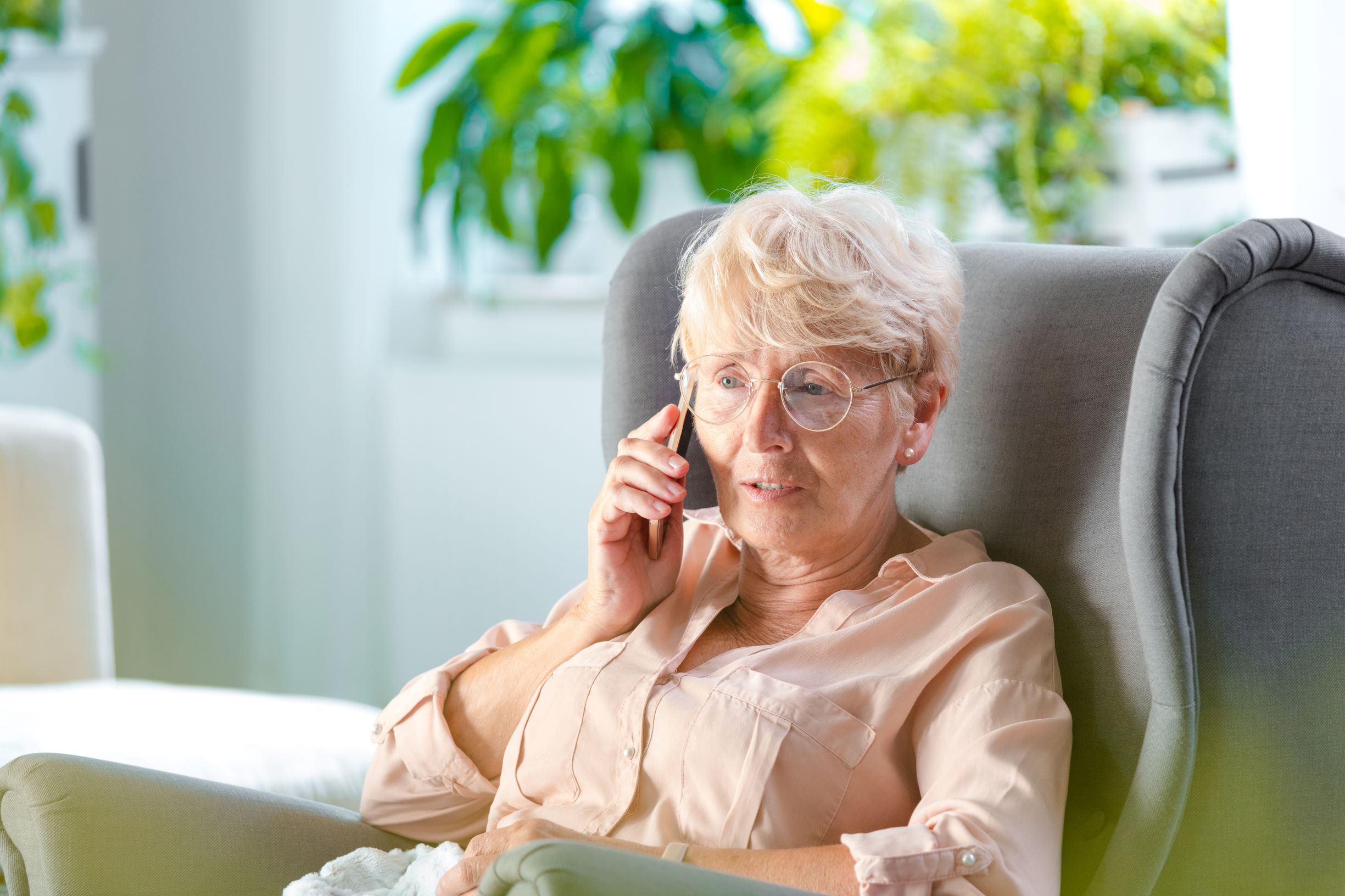 A senior woman focuses on her phone conversation. The relationship between hearing loss and cardiovascular health is well documented.